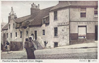 A postcard showing thatched houses in Ladywell Street looking north across Duke Street, Glasgow early 1900s
