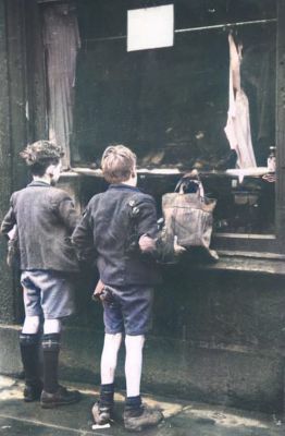 Boys in Threadbare Clothes looking through the Window of a dilapidated Shop,  Glasgow 31st January 1948
