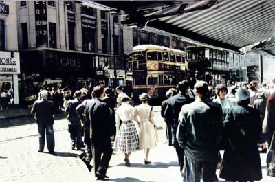 Crowds in Argyle Street, viewed from beneath a shop awning on the north side of the street near the entrance to the Argyll Arcade, 1955

