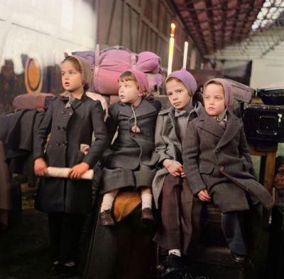 Four children sitting on luggage deposited on the dockside at Glasgow where soldiers of the 1st Battalion, the Royal Scots arrived after returning from India aboard the troopship Empire Halladale, January 12th 1948
