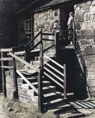 Stairhead gossip at the ex weaving Sheds near Parkhead Cross, Glasgow 1955

