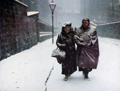 Two women trudge through snow in Garnet Street, Glasgow in 1952.
