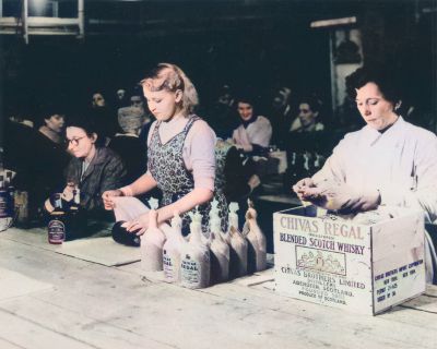Women wrapping bottles of Chivas Regal, and packing them in wooden cases for export, Glasgow 20th Century
