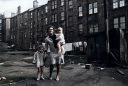 Happy_Looking_Woman_And_Children_In_A_Slum_Back_Court_In_Maryhill_Glasgow_1970.jpg